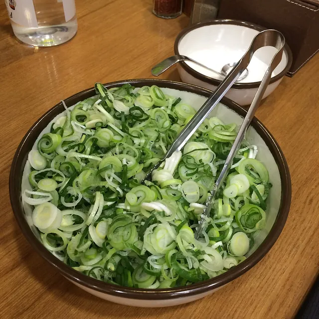 Chopped scallions. Actual chopped scallions, showing the cut rings used as a fresh garnish. This is an ingredient photograph, not a measured ramen serving.